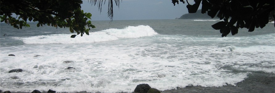 Black sand beach on the island of Tahiti where the surfers play.